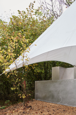 Photograph of The Missing Room pavilion by Carroccera Collective, an open-air living space immersed in the forest, Piedmont, Italy.