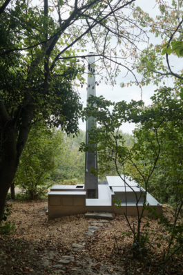 Photograph of The Missing Room pavilion by Carroccera Collective, an open-air living space immersed in the forest, Piedmont, Italy. 