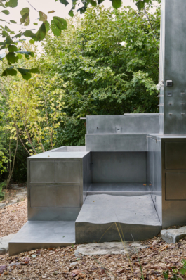 Photograph of The Missing Room pavilion by Carroccera Collective, an open-air living space immersed in the forest, Piedmont, Italy.