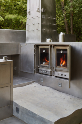 Photograph of The Missing Room pavilion by Carroccera Collective, an open-air living space immersed in the forest, Piedmont, Italy.
