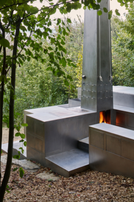 Photograph of The Missing Room pavilion by Carroccera Collective, an open-air living space immersed in the forest, Piedmont, Italy.